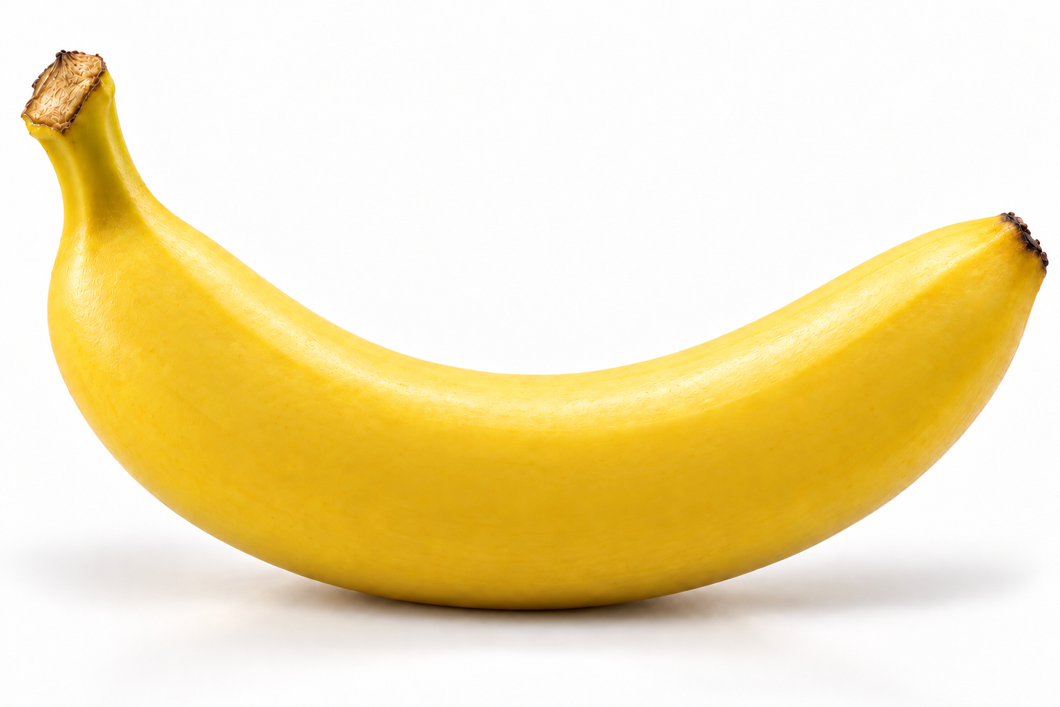 A bright yellow banana with its stem curving upward, photographed on white with a soft natural shadow.